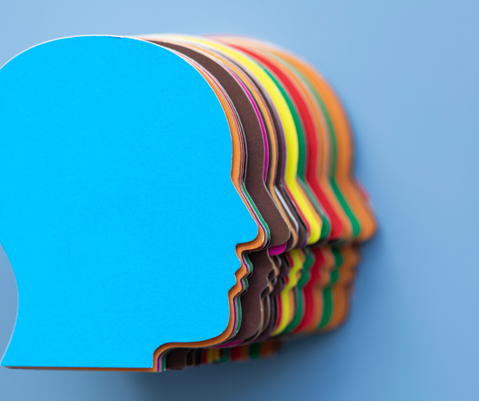 a series of paper cutouts resembling human heads, each in a different color