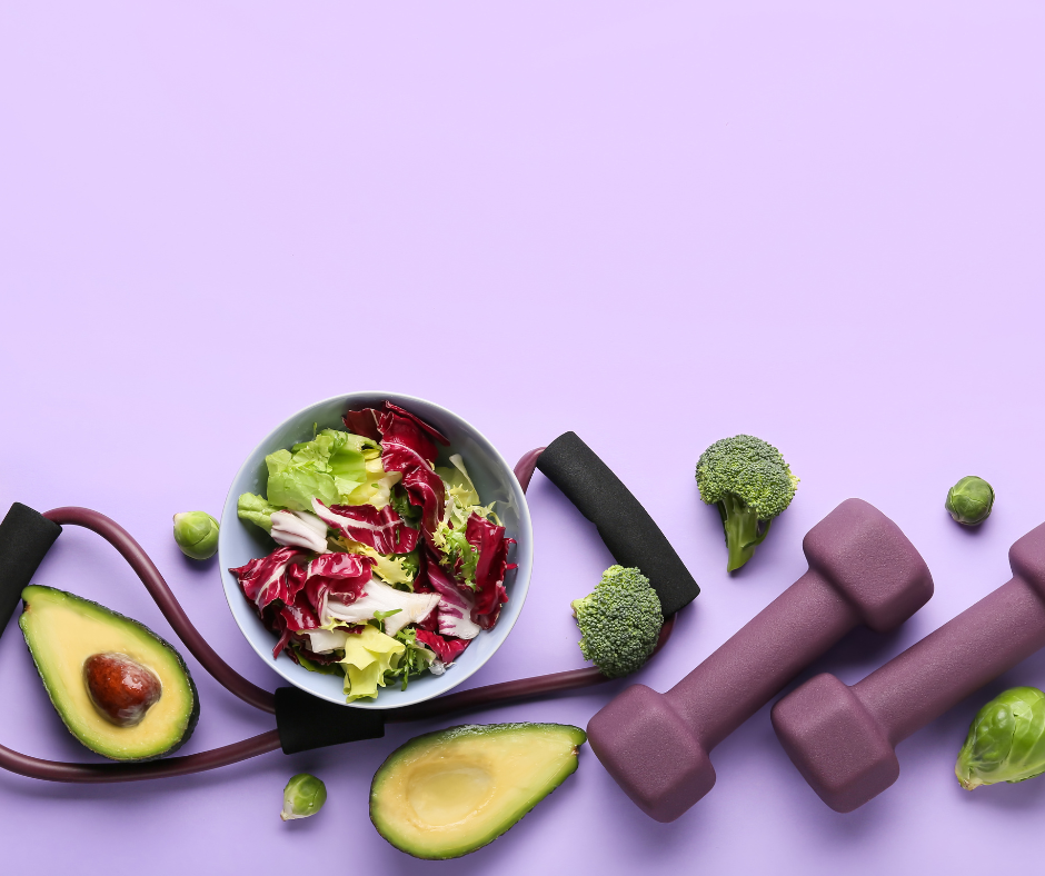 a photograph of a salad, avocado, and dumbbells against a plain purple background